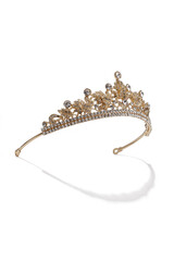 Subject shot of golden tiara adorned with a plenty of diamond-like gems and clear sparkling rhinestones that form fanciful pattern. The luxury queen crown is isolated on the white backdrop.