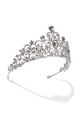 Subject shot of silver tiara adorned with clear sparkling gems and rhinestone that form fanciful pattern. The luxury queen crown is isolated on the white backdrop. © RedUmbrella&Donkey
