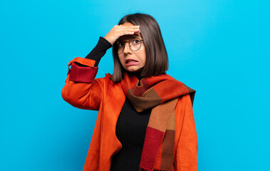 hispanic woman panicking over a forgotten deadline, feeling stressed, having to cover up a mess or...
