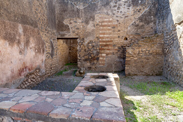 Close-up of a hearth for heating food for sale. Ruins of the ancient city of Pompeii, which was killed by the eruption of Mount Vesuvius.