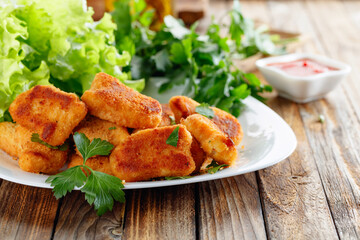 Fried chicken nuggets with ketchup.