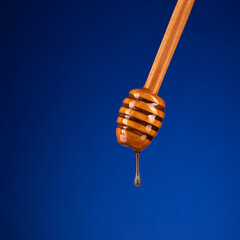 honey on a spoon on a blue background