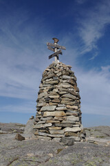 Norway stone cairn with cirrus clouds