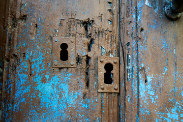 Old doors in colors and with aged paint.