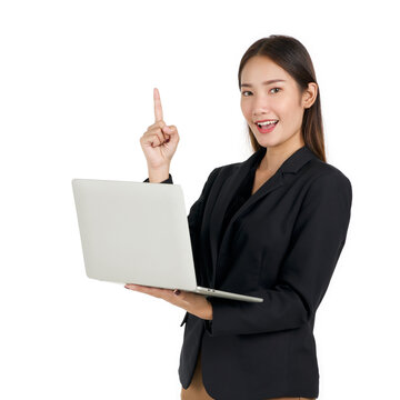 Young asian businesswoman in a black suit holding a laptop computer pointing one finger in upward direction. Portrait on white background with studio light.