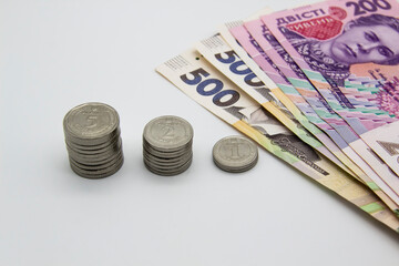 Ukrainian money on a light background. Banknotes and metal coins all together