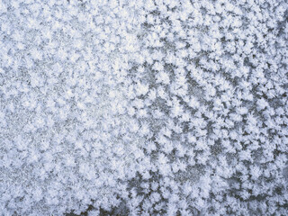 Frosty patterns on ice. Winter and frost texture.