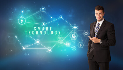 Businessman in front of cloud service icons with SMART TECHNOLOGY inscription, modern technology concept