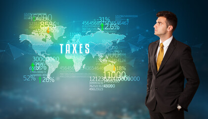 Businessman in front of a decision with TAXES inscription, business concept