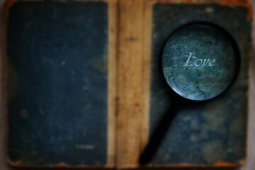 old book and magnifying glass