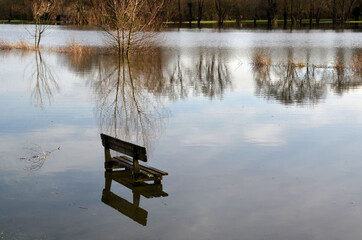 The public bench and the swollen river.
