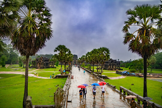  Angkor Wat-largest Temple In The World. It Is Raining. Tourists Walk Around The Temple