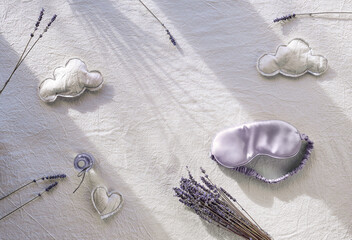 Healthy night sleep creative concept with lavender color. Off white, ivory textile background. Silk...