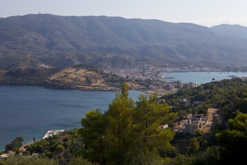 View from the mountain to a small town and nature on the island of Poros. Greece. Panorama.
