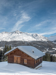 Snow covered cabin in de the alps