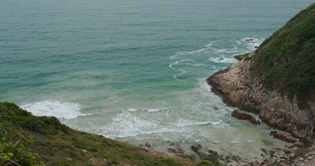 Cliff with sand beach on island