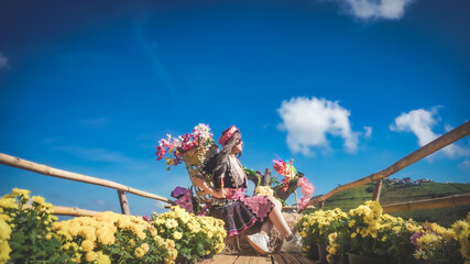 Young hill tribe girl form a village take photo to travel at Monjam, Chiangmai, Thailand