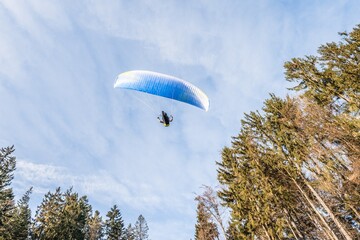 Startender Hobby Gleitschirm Flieger an einem Berghang mit professioneller Ausrüstung im Herbst,...