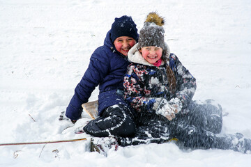 Fototapeta na wymiar European kids play under snow fall.Fun.