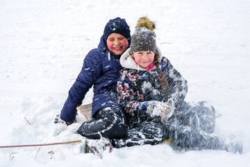 European kids play under snow fall.Fun.