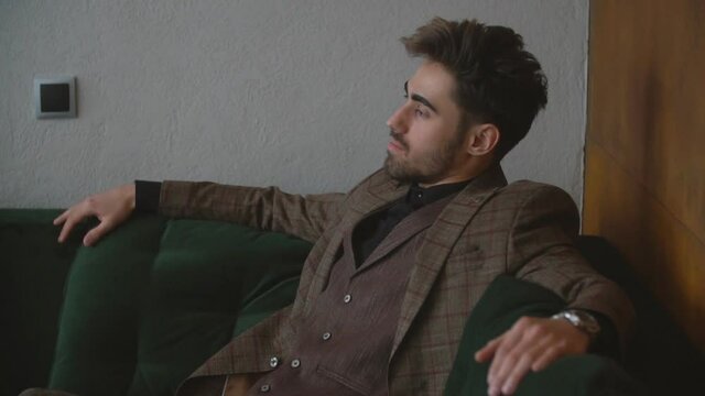 guy in a suit sitting on the couch