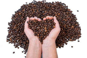 coffee beans close-up on the palm in the shape of a heart against the background of other coffee beans