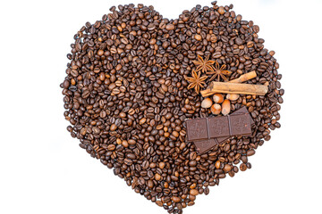 coffee beans close-up in the shape of a heart, top cinnamon, hazelnuts and chocolate