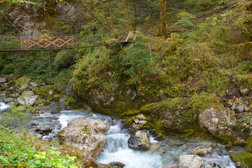 Naklejka na ściany i meble A bridge over the Zadlascica River near its confluence with Tolminka River in Tolmin Gorge, Triglav National Park, western Slovenia 