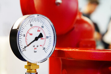 Pressure sensor in the hot water system. Mechanical barometer in an industrial boiler room. Close-up