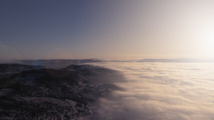 Obraz premium Fog and clouds in a valley at sunset in a wilderness winter wonderland.