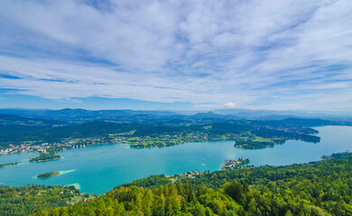 Naklejka na ściany i meble Aerial view of the alpine lake Worthersee, famous tourist attraction for many water activity in Klagenfurt, Carinthia, Austria.