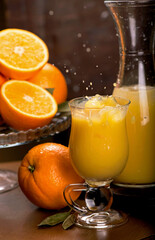 glass of fresh orange juice with fresh fruits on wooden
