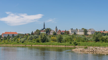 Skyline of the historical royal city on the bank of the Vistula river - panoramic view from riverboat cruise, Sandomierz, Poland