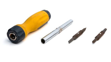 Bisassembled multi-bit screwdriver with replaceable bits on a white background. Close-up view of repair work tool. Selective focus on objects