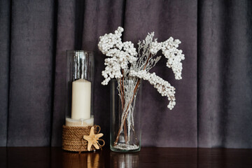 glass candle holder and vases with dried flowers painted in white. Original Christmas decor. decorating the house, restaurant, cafe for the new year.