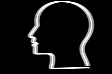 sign of human head . red led lamp. isolated on black background. illuminated sign . side view.