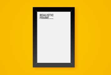 Realistic vertical picture frame isolated on yellow wall background. Blank picture frame template. Empty photo frame mockup.