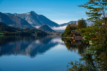 Autumn morning with patches of fog on the lake Grundlsee, Styria, Austria.
