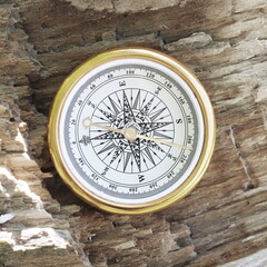 round compass on natural wooden background as symbol of tourism with compass, travel with compass...