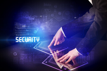 Hand touching digital table with SECURITY inscription, new age security concept