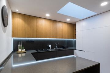 Fototapeta na wymiar Interior of modern kitchen with built-in appliances in a house