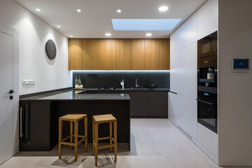 Interior of modern kitchen with built-in appliances in a house