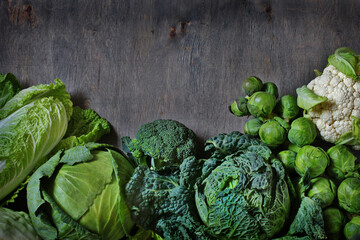 Fototapeta na wymiar different kinds of cabbage background. Copy space. broccoli, brussels sprouts, cabbage, Savoy cabbage, cauliflower, Peking cabbage. The concept of healthy diet food. Flat lay