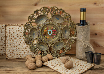 Passover background. Wine, matzoh and vintage traditional Pesah plate with text in hebrew: Passover, horseradish, celery, egg, bone, maror, charoset.