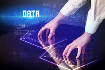 Hand touching digital table with DATA inscription, new age security concept