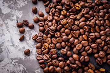 aromatic fresh coffee beans on a dark stone background