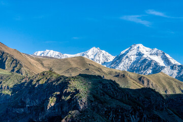 Snow Capped Mountains Under Blue Sky, Stepantsminda (Kazbegi), Georgia.