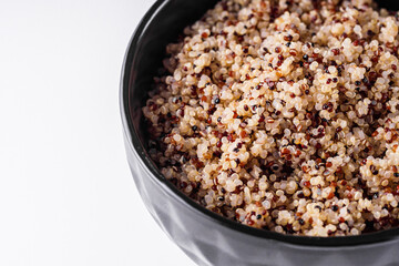 bowl of healthy quinoa on a white acrylic background