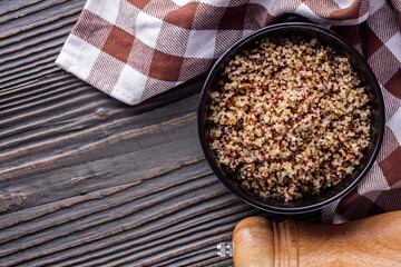 bowl of healthy quinoa on a dark wooden rustic background