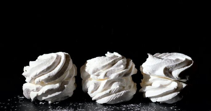 Pouring hot melt chocolate on Marshmallow, black background, close-up, macro